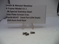 Three screws on a white surface with a label for Smith & Wesson Revolver K Frame Model 64-3.