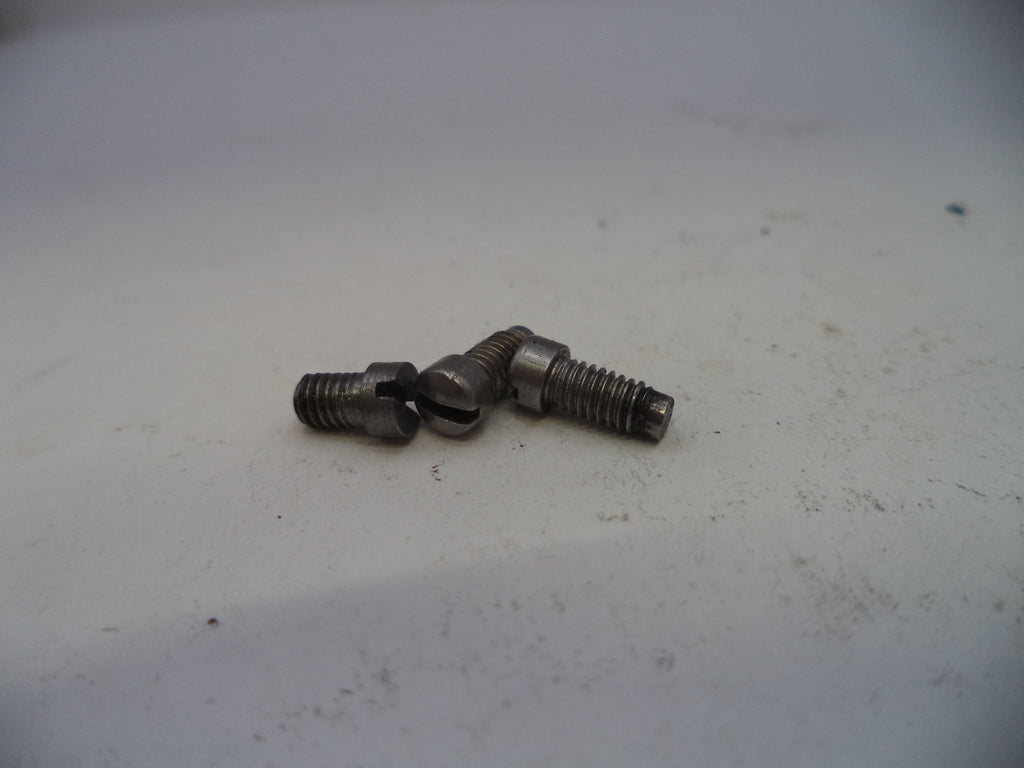Two metal screws on a white surface