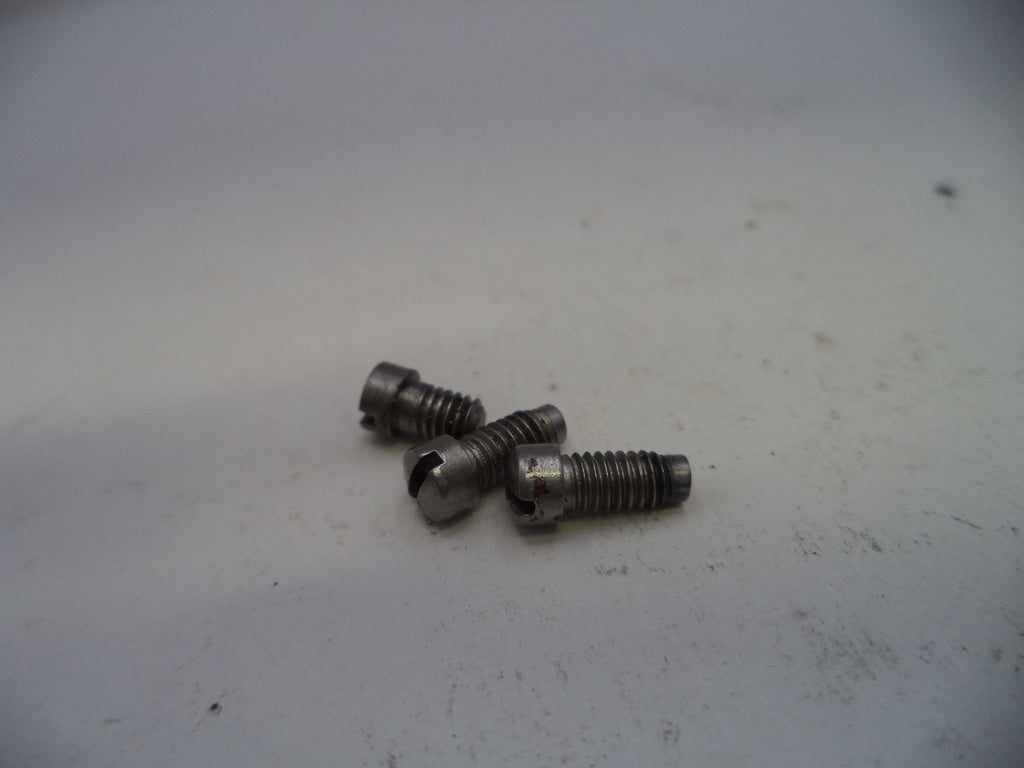 Three metal screws on a white surface