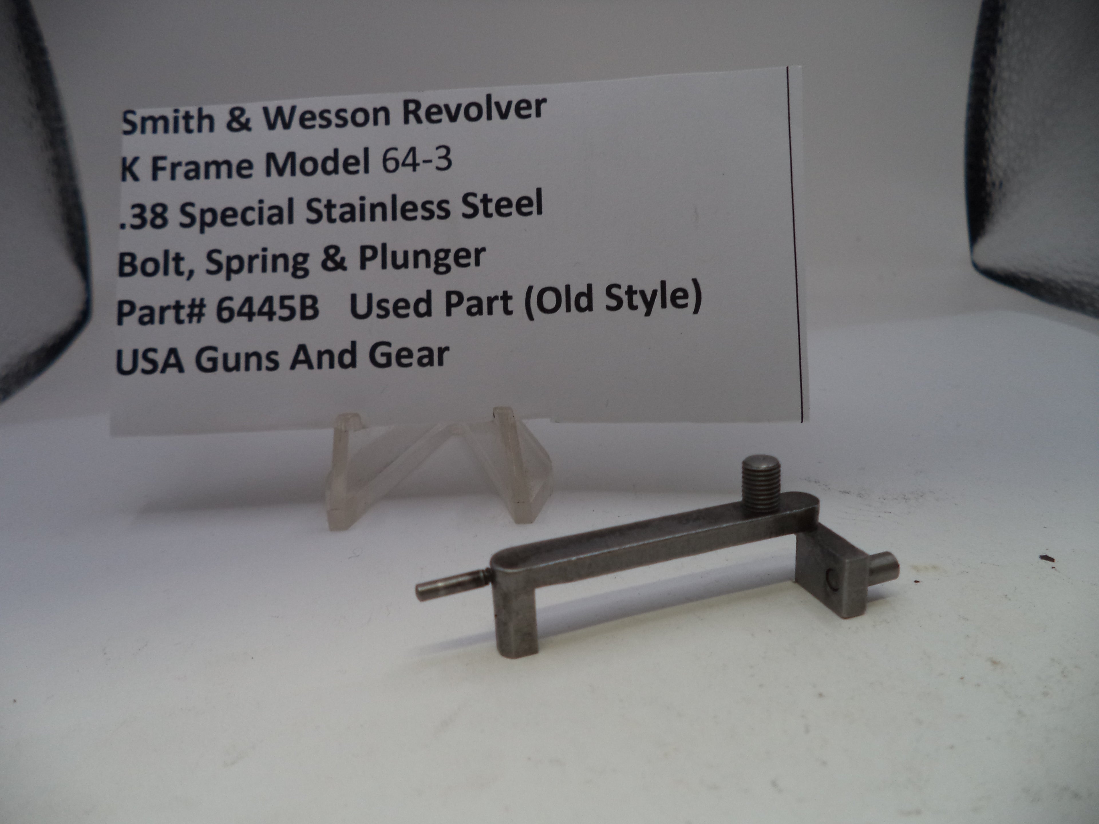 Smith & Wesson revolver part on a white background with descriptive text card.