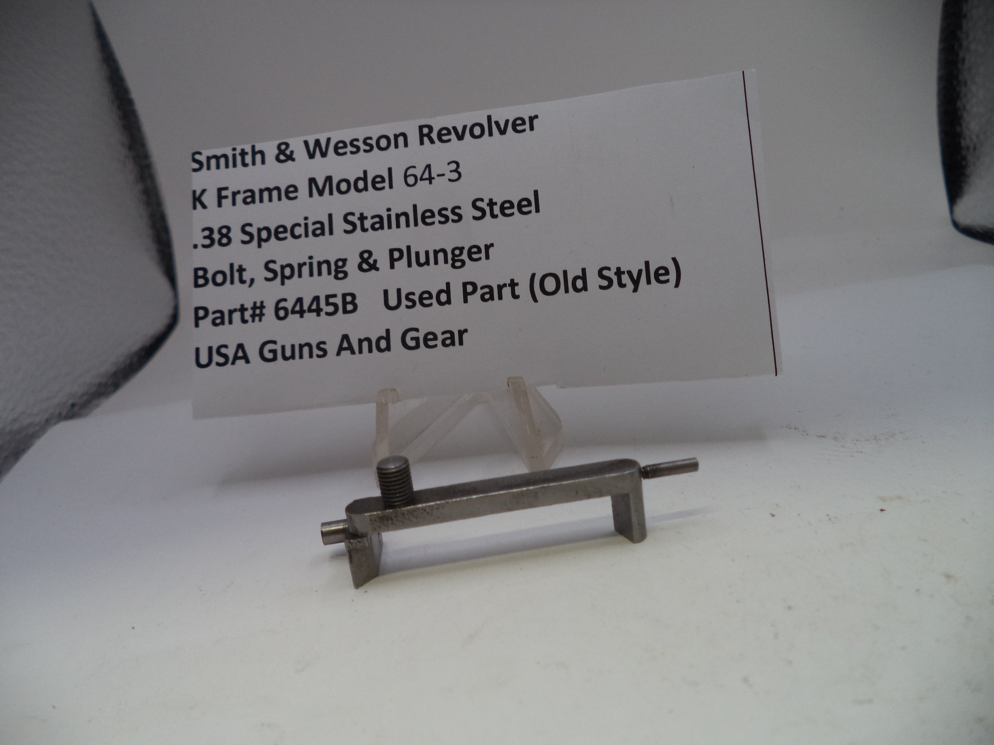Smith & Wesson revolver part with descriptive card on a white background