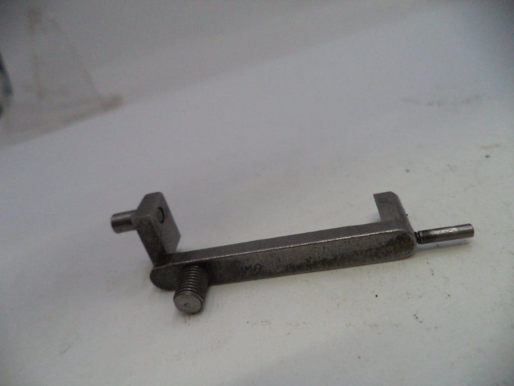 Metal toggle bolt on a white surface