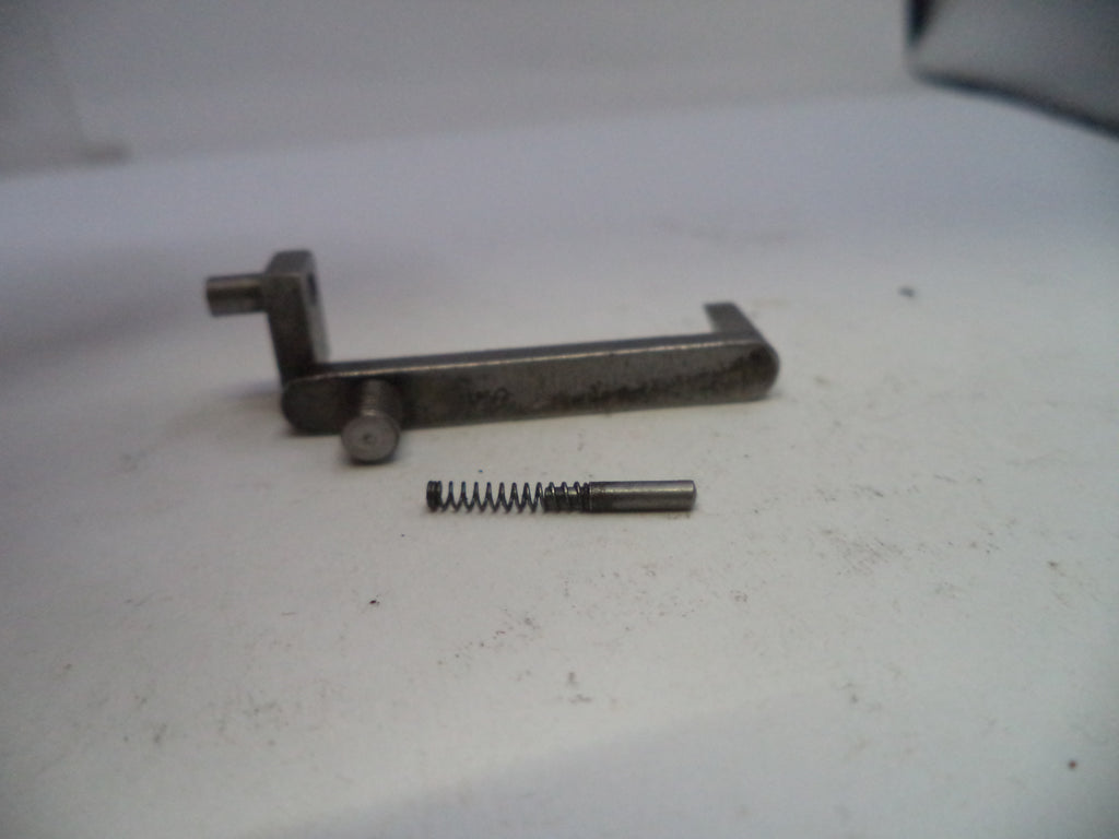 Metal lever and spring on a white surface
