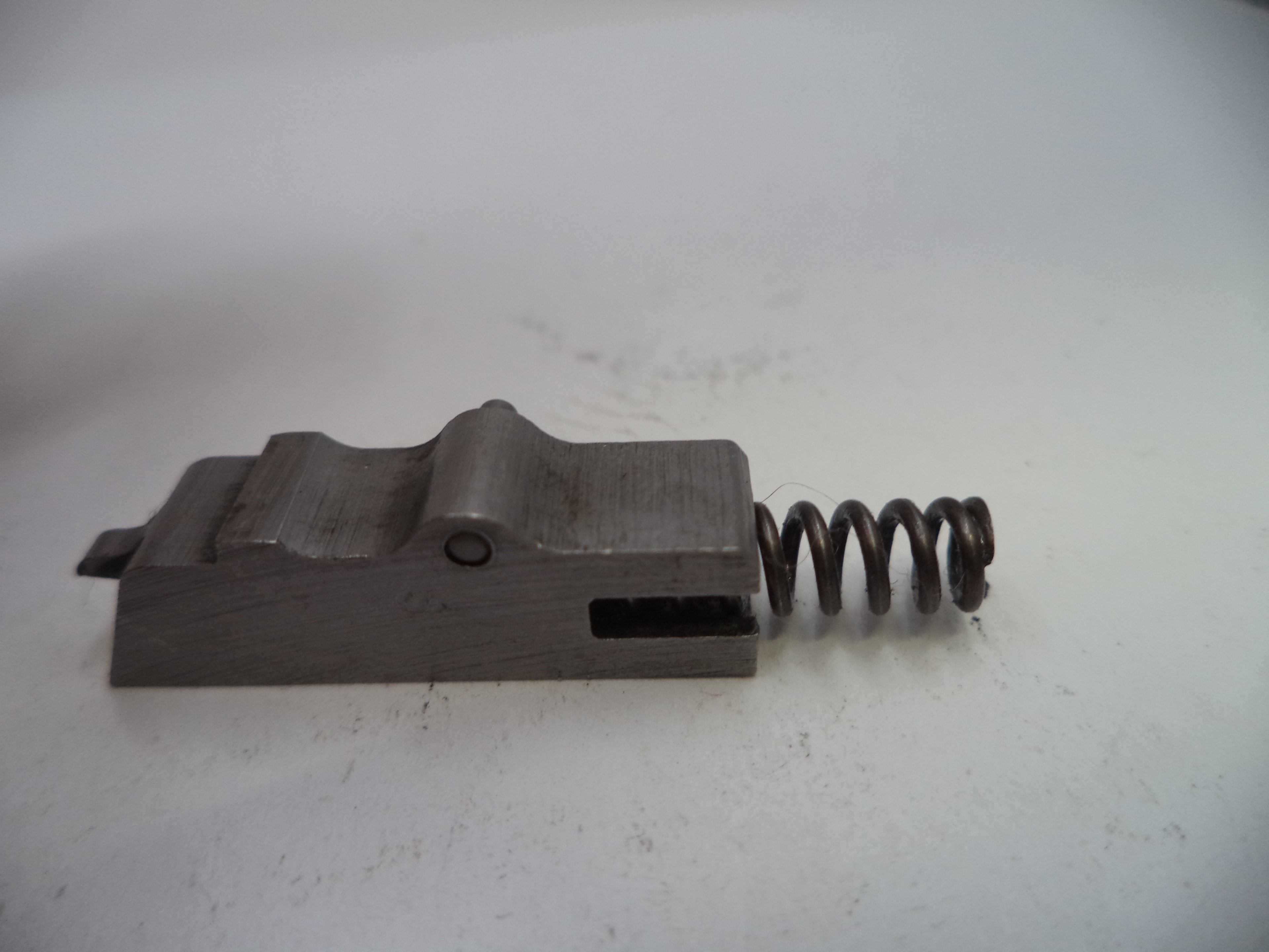 Metal component with a spring on a white background