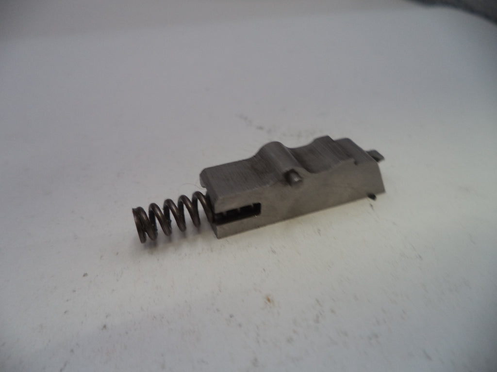 Mechanical component with a spring on a white surface