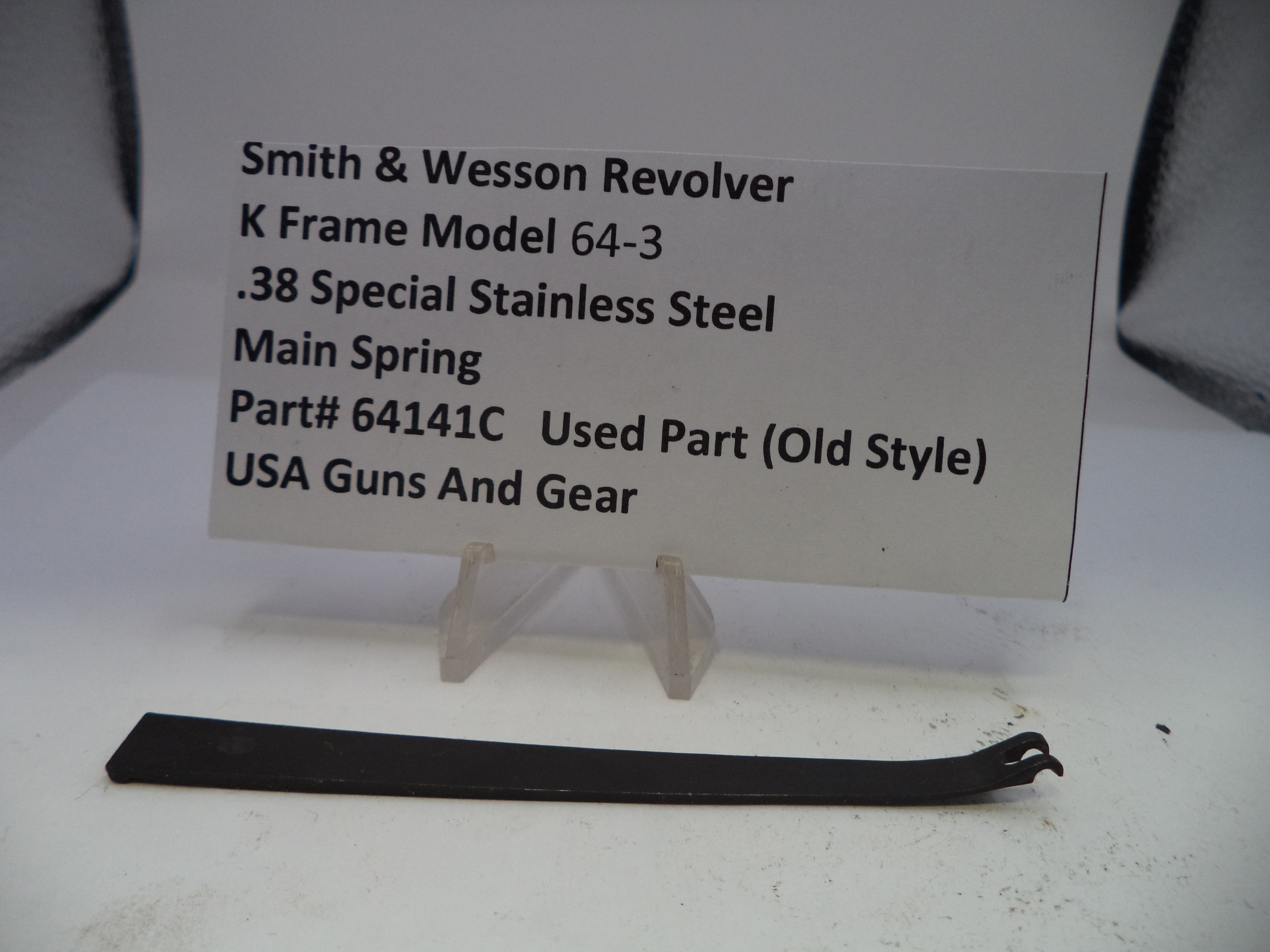 Smith & Wesson revolver main spring part with descriptive label on a white background