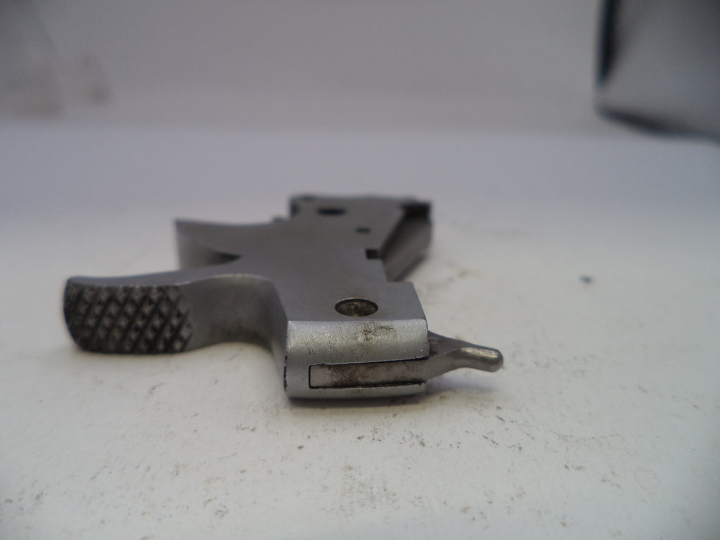 Metal gun stock on a white surface