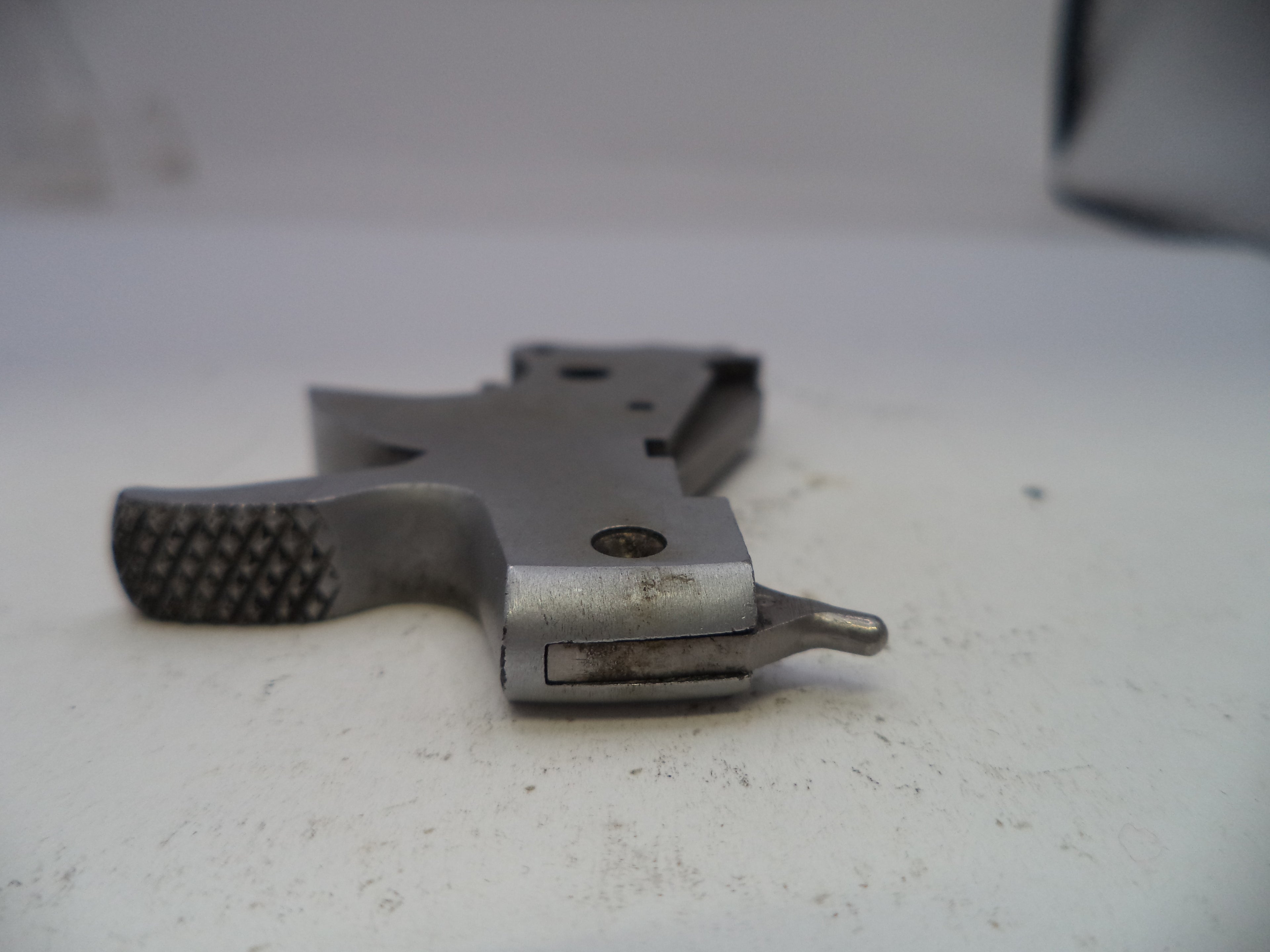 Metal gun stock on a white surface