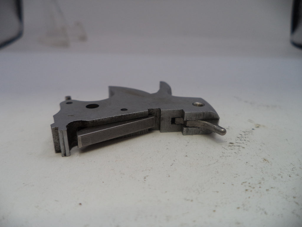Metallic tool or component on a white surface