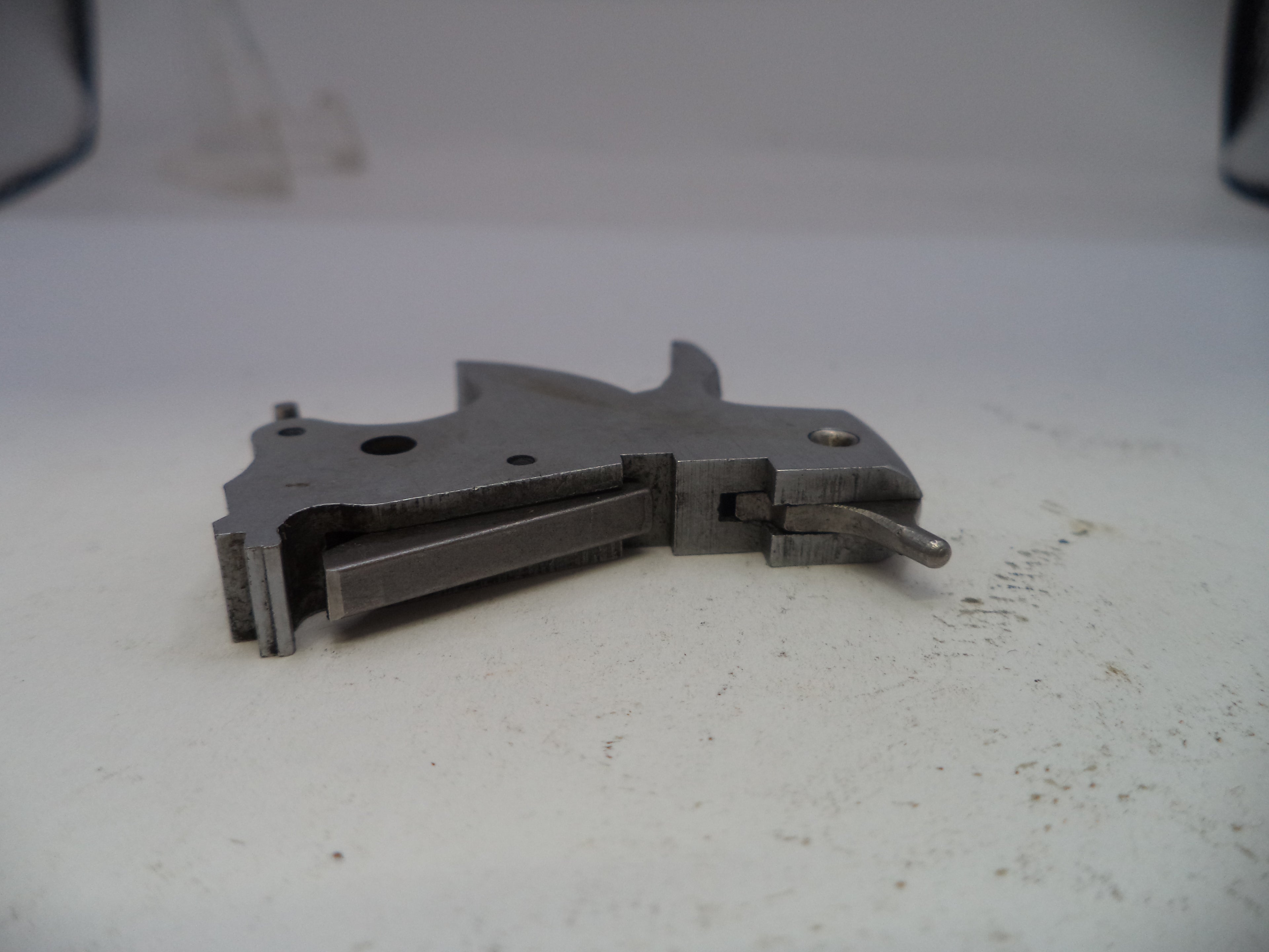 Metallic tool or component on a white surface