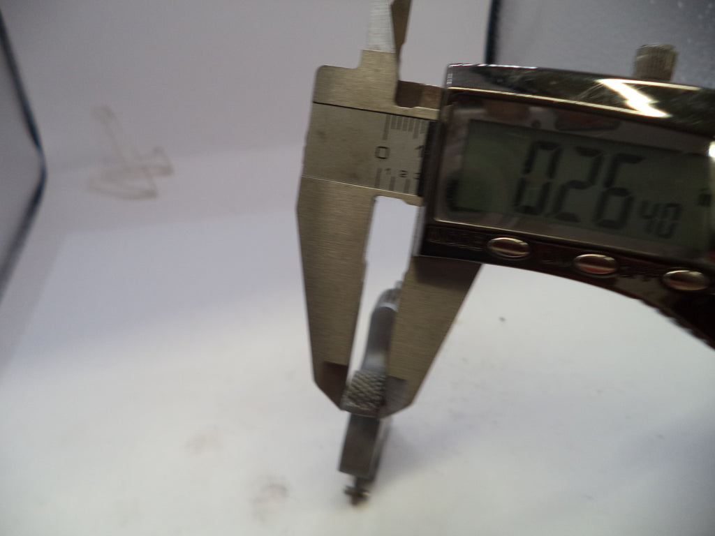Digital caliper measuring a small object on a white background