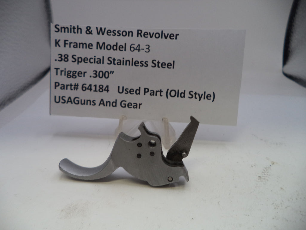 Smith & Wesson revolver trigger part with descriptive label on a white background