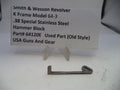 Smith & Wesson revolver hammer block on a white surface with a label in the background.