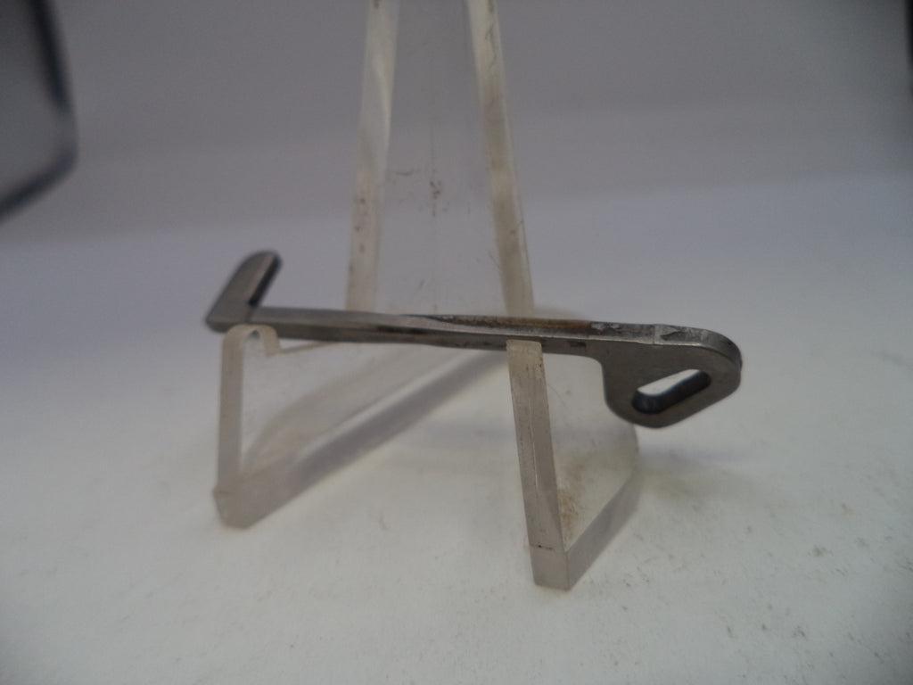 Metallic object on a stand against a white background
