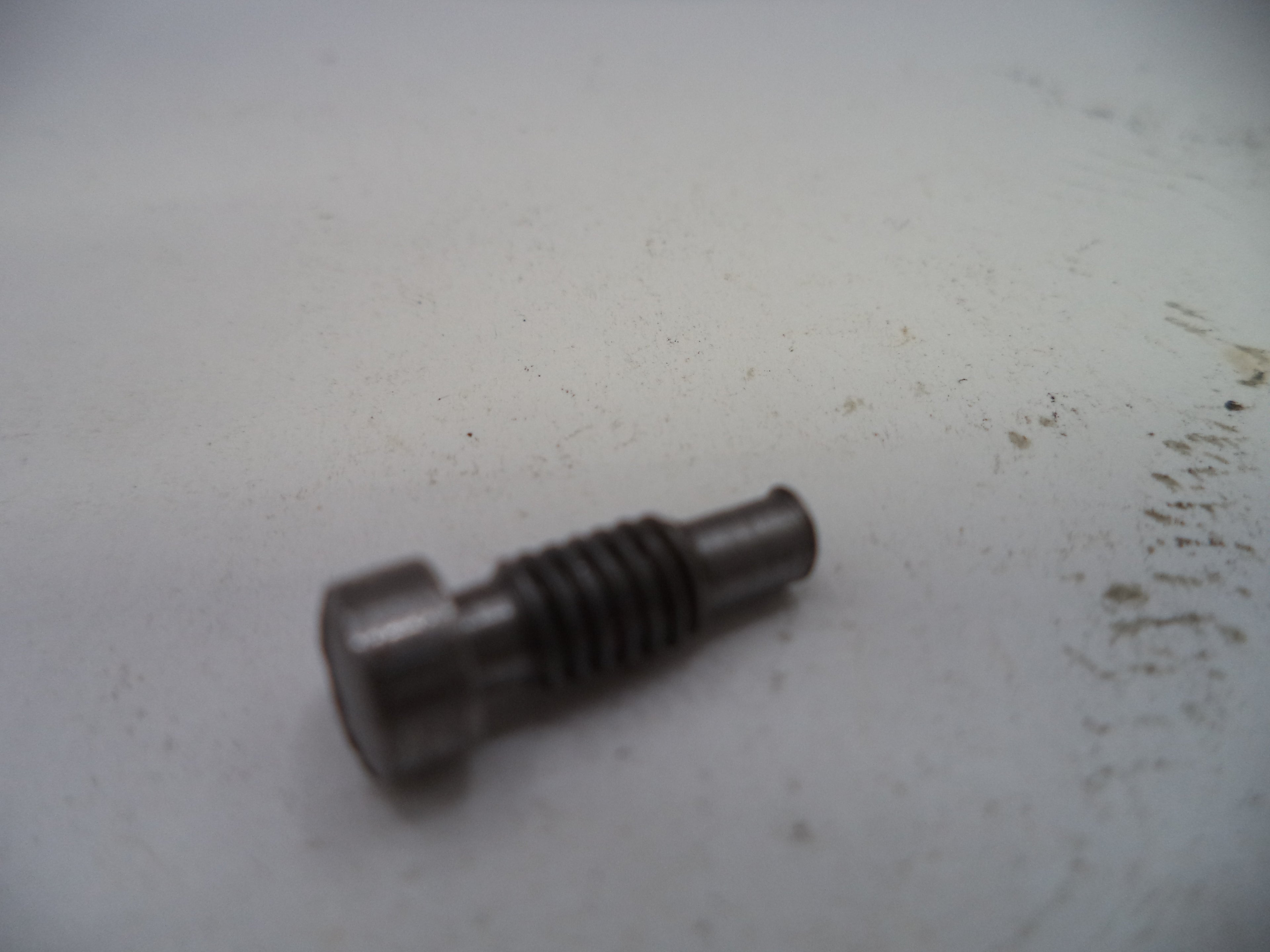 Metal bolt on a white surface