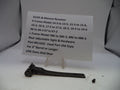 Smith & Wesson revolver part with a label on a white background