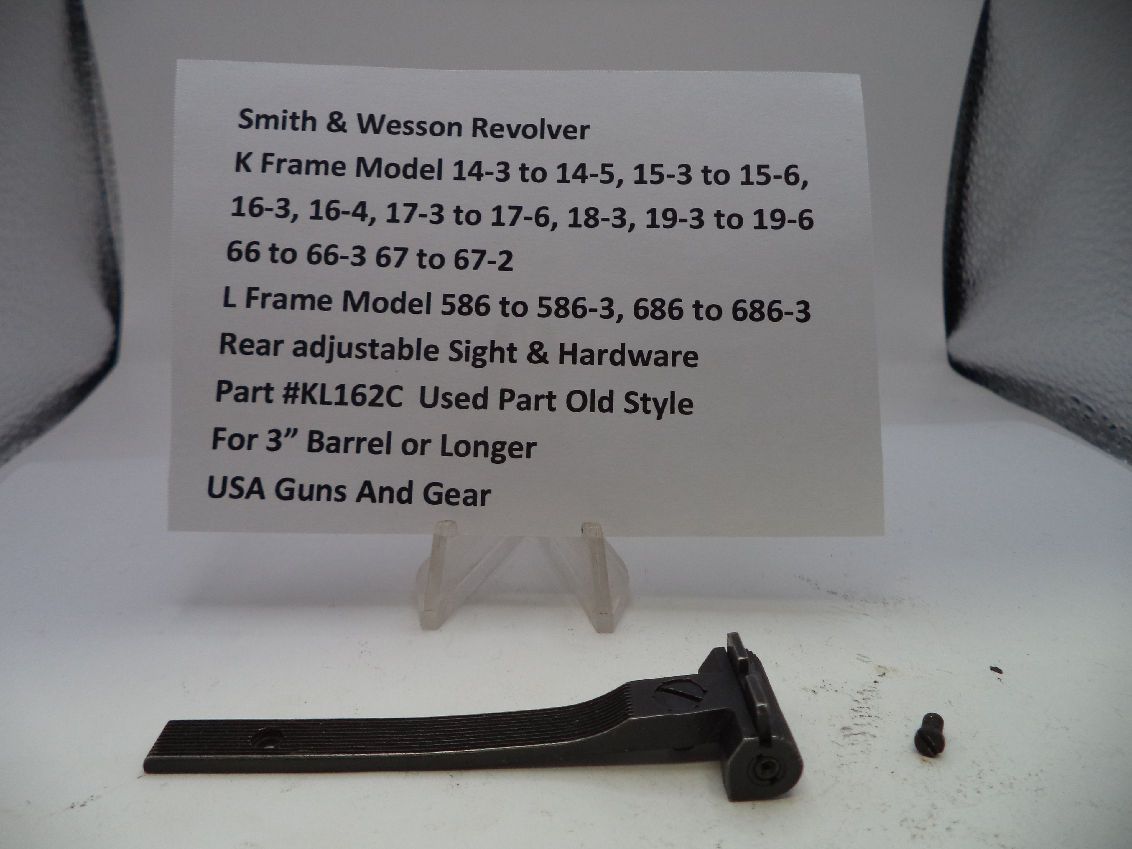 Smith & Wesson revolver part with a label on a white background