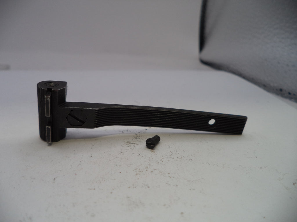 Black metal bracket on a white surface with a blurred background
