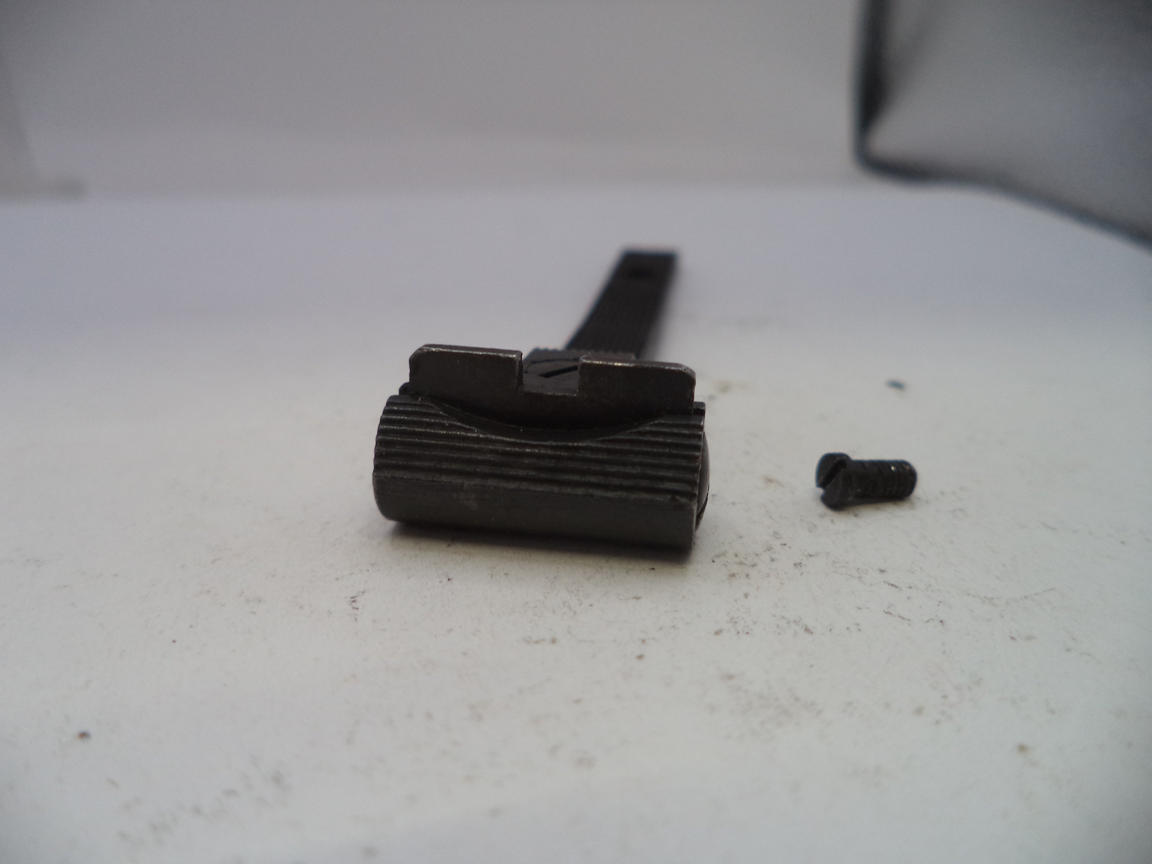 Black metal component on a white surface