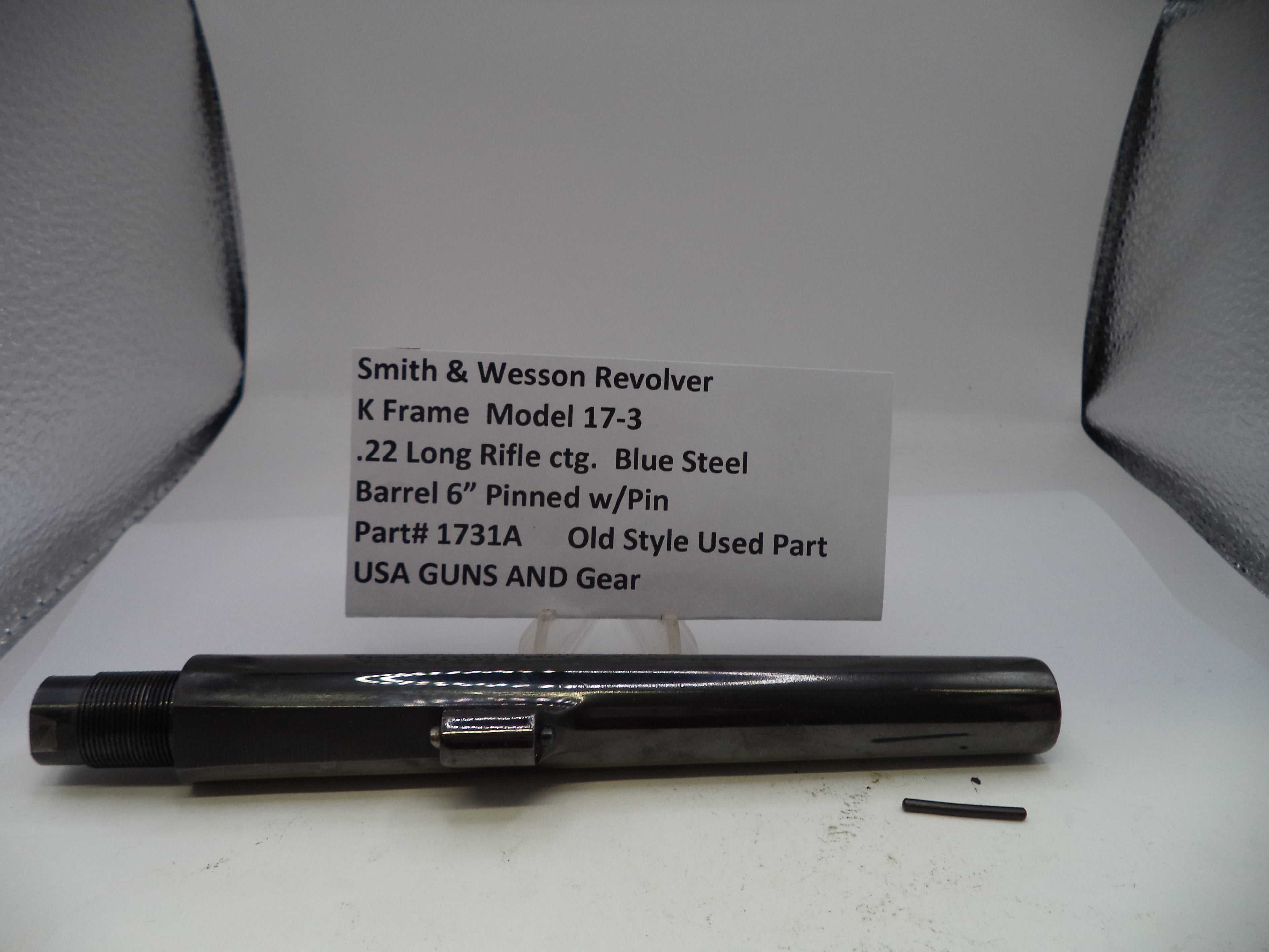 Smith & Wesson revolver barrel with descriptive card on a white background