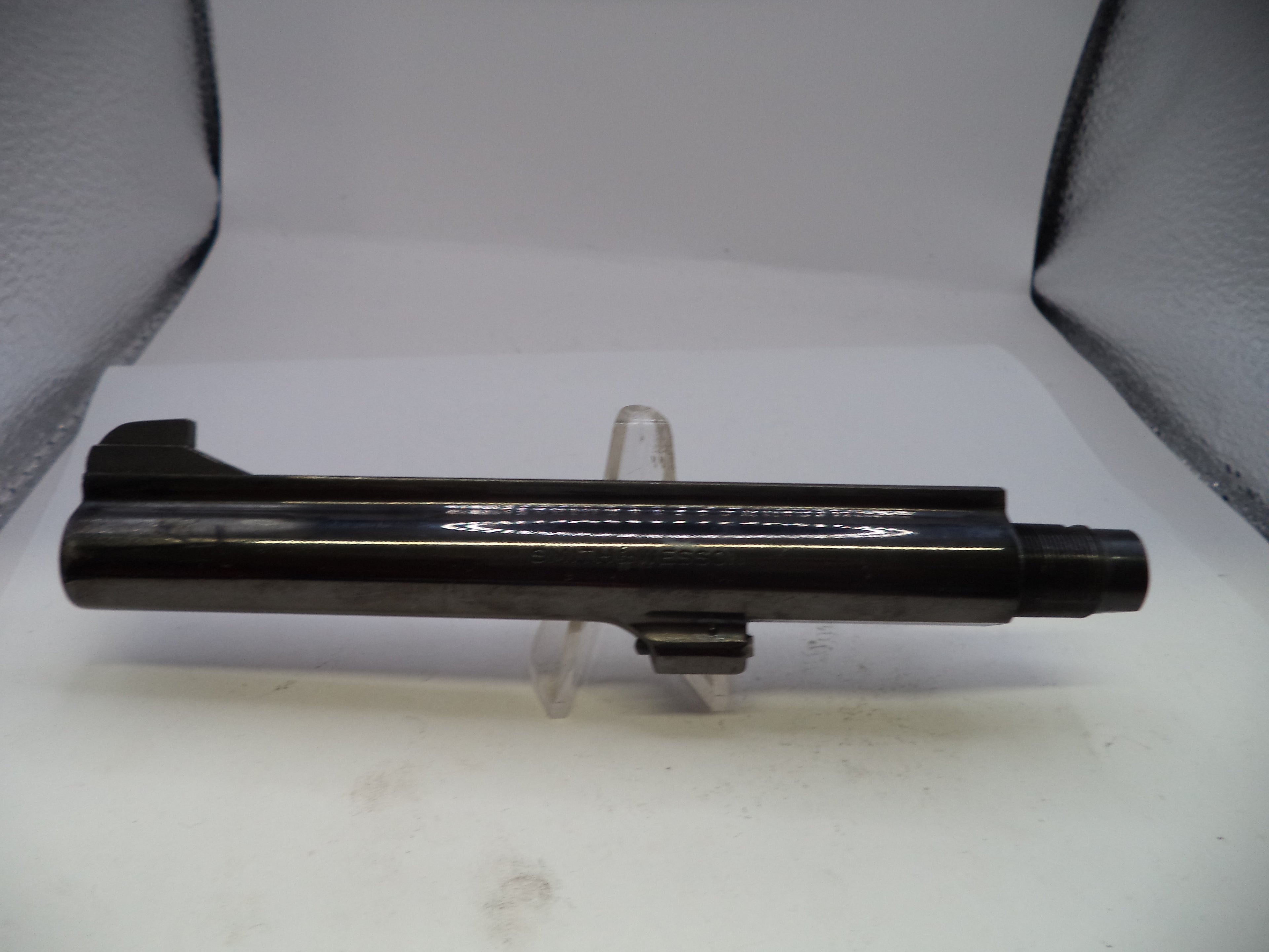 Black metal rod on a white stand against a light gray background