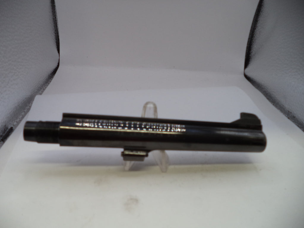 Black metal object on a white stand with a gray background