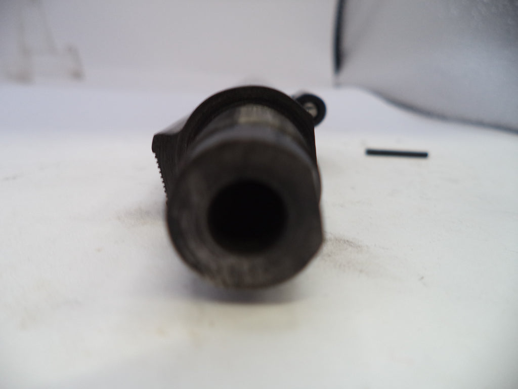 Close-up of a black cylindrical object on a white surface