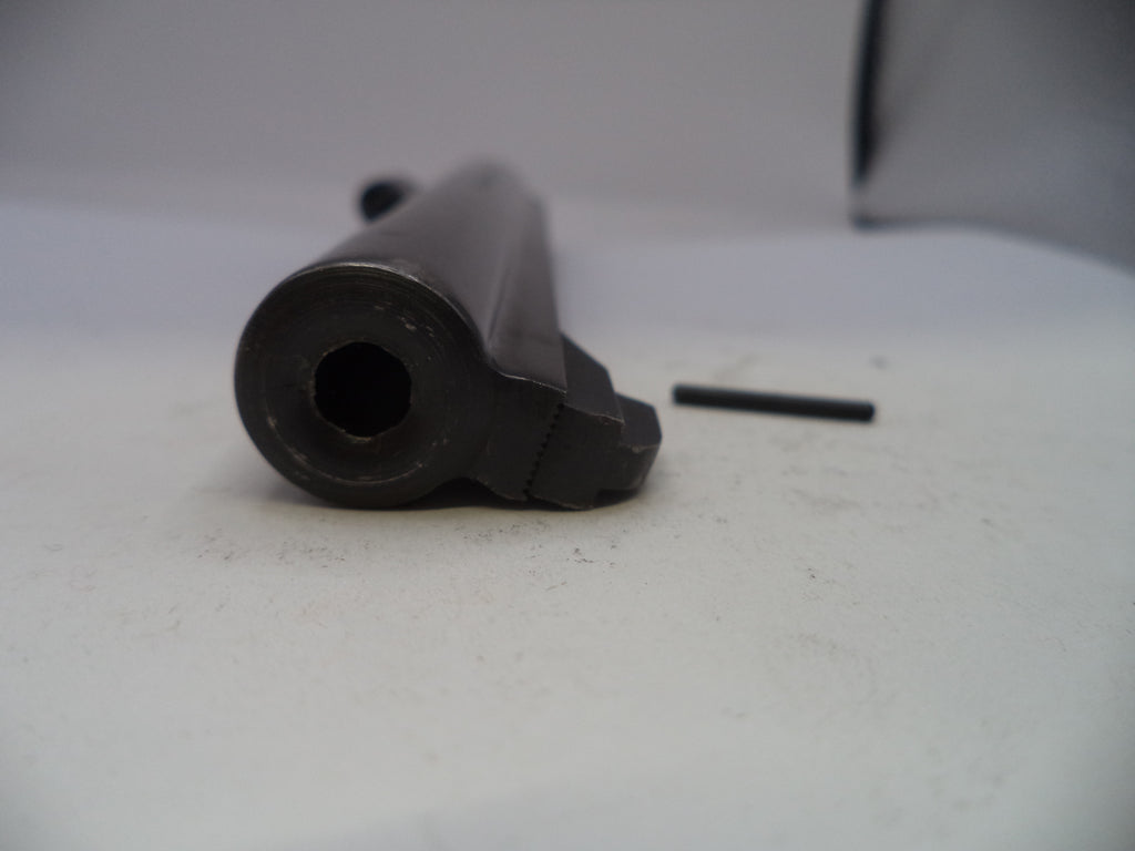 Black cylindrical object on a white surface with a blurred background