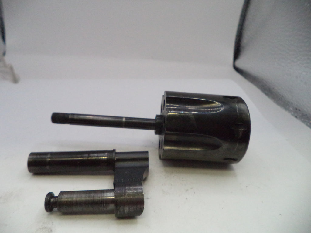 Three metal cylindrical components on a white surface