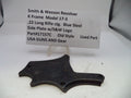 Smith & Wesson revolver side plate with descriptive label on a white background