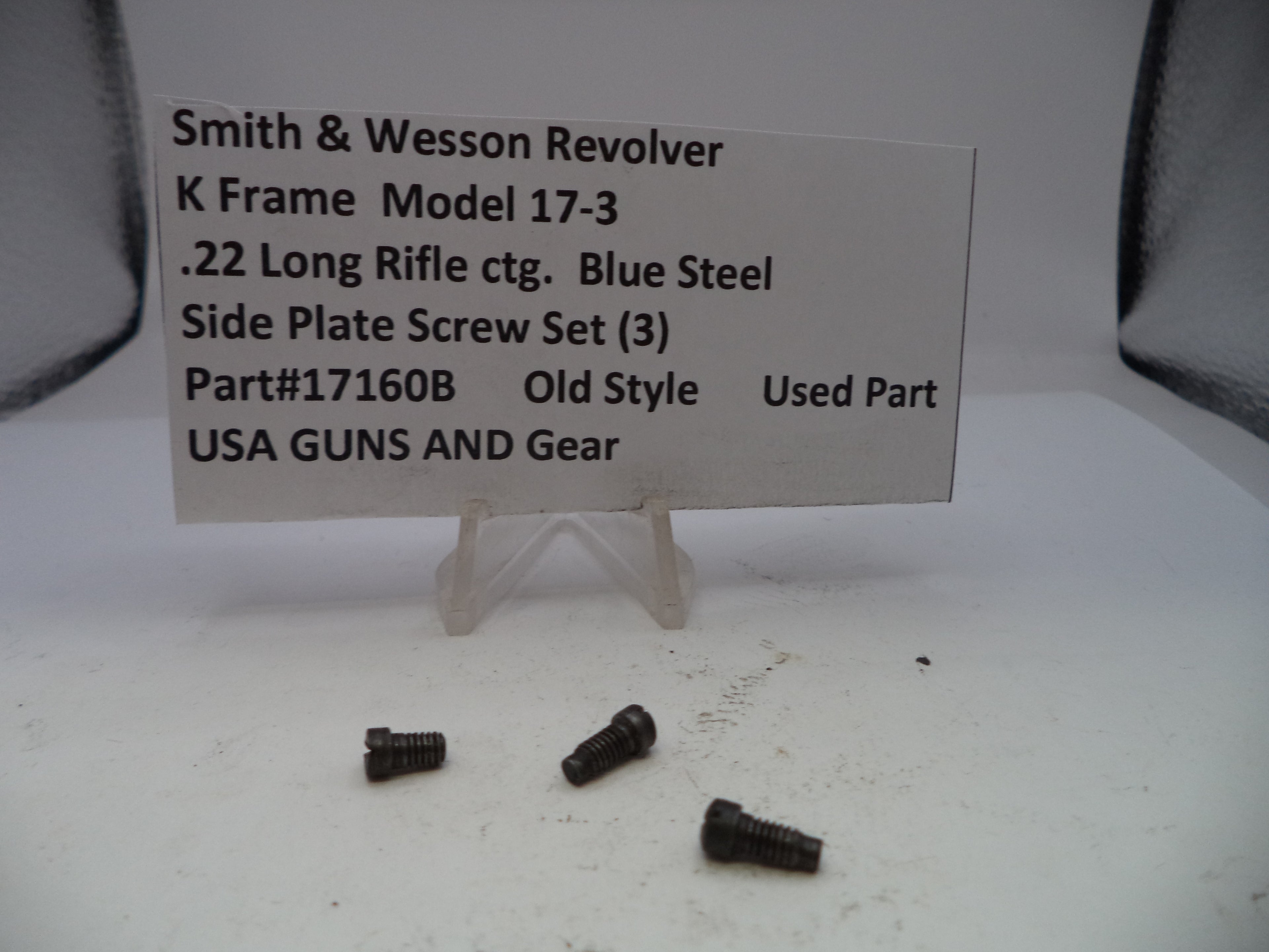 Three black screws on a white surface with a label for Smith & Wesson Revolver side plate screw set.