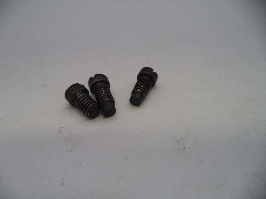 Three black screws on a light gray background
