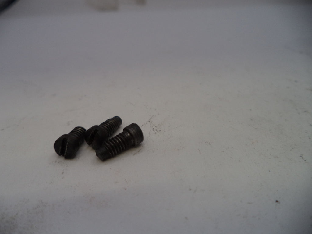Three black screws on a white surface