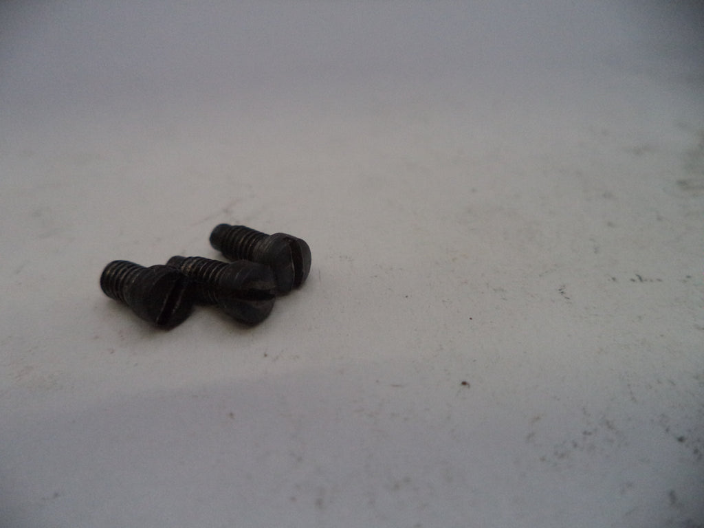 Two black screws on a light gray surface