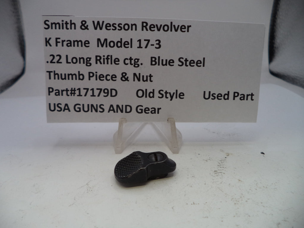 Small black metal part on a white surface with descriptive text card.