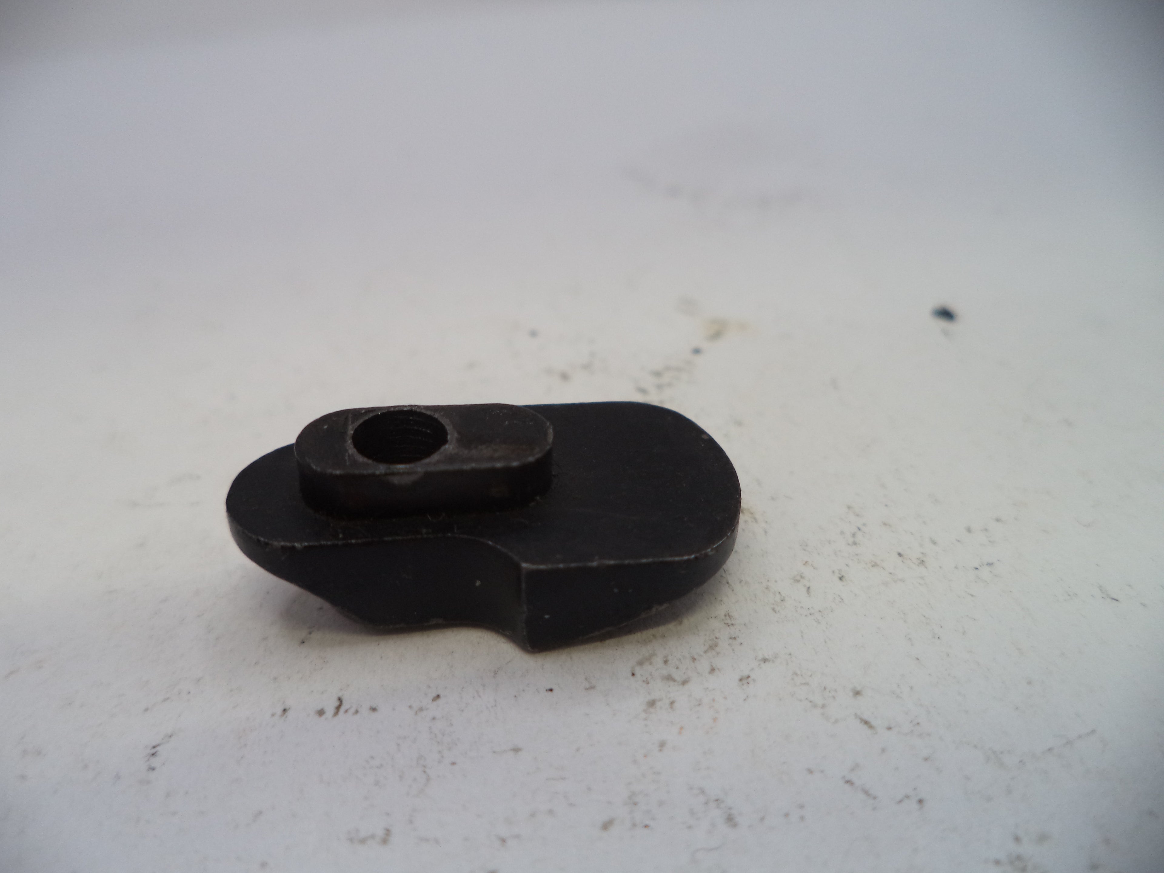Black mechanical component on a white background