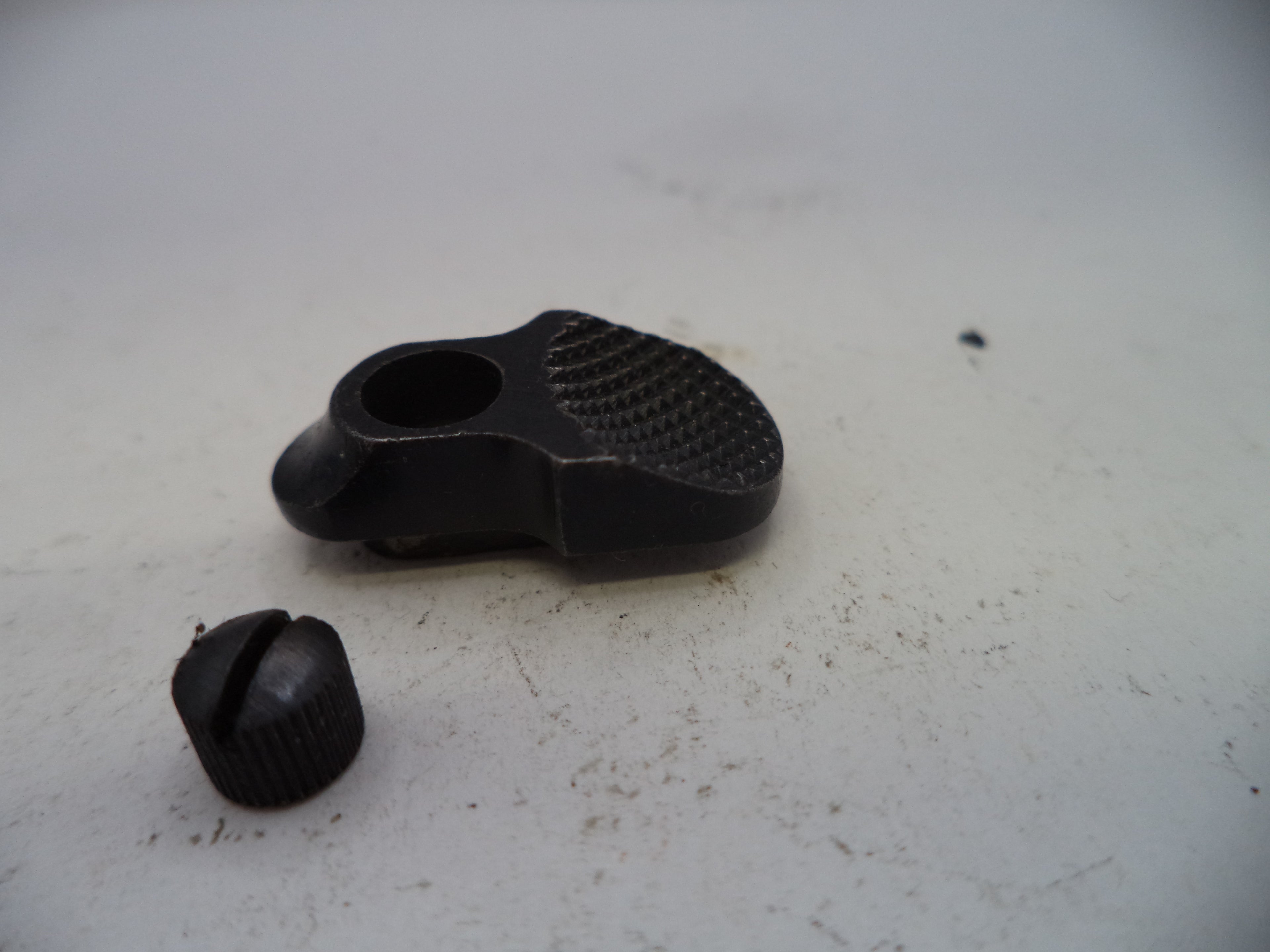 Two black rubber components on a light gray surface
