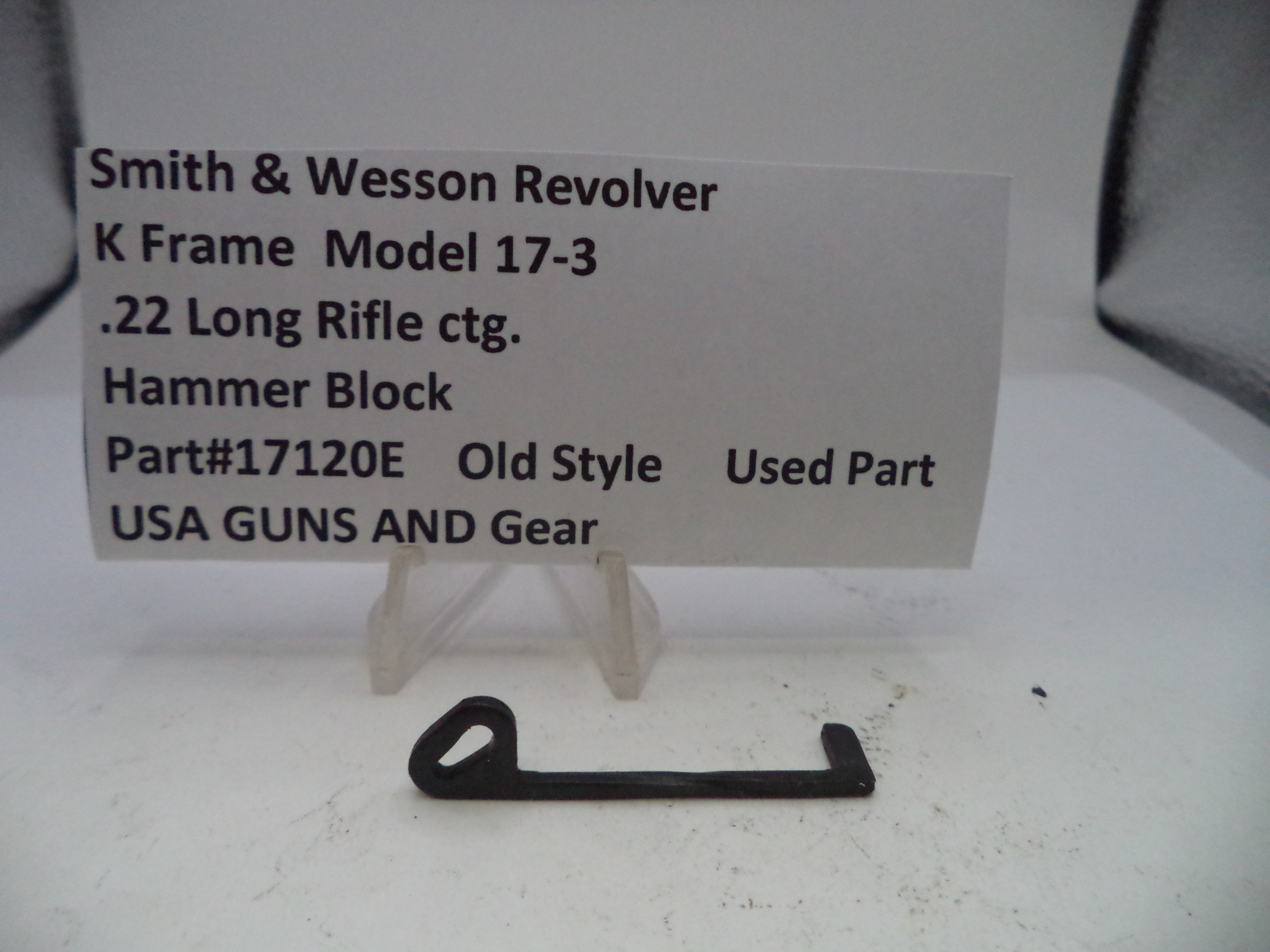 Smith & Wesson revolver hammer block part on a white background with descriptive text card.