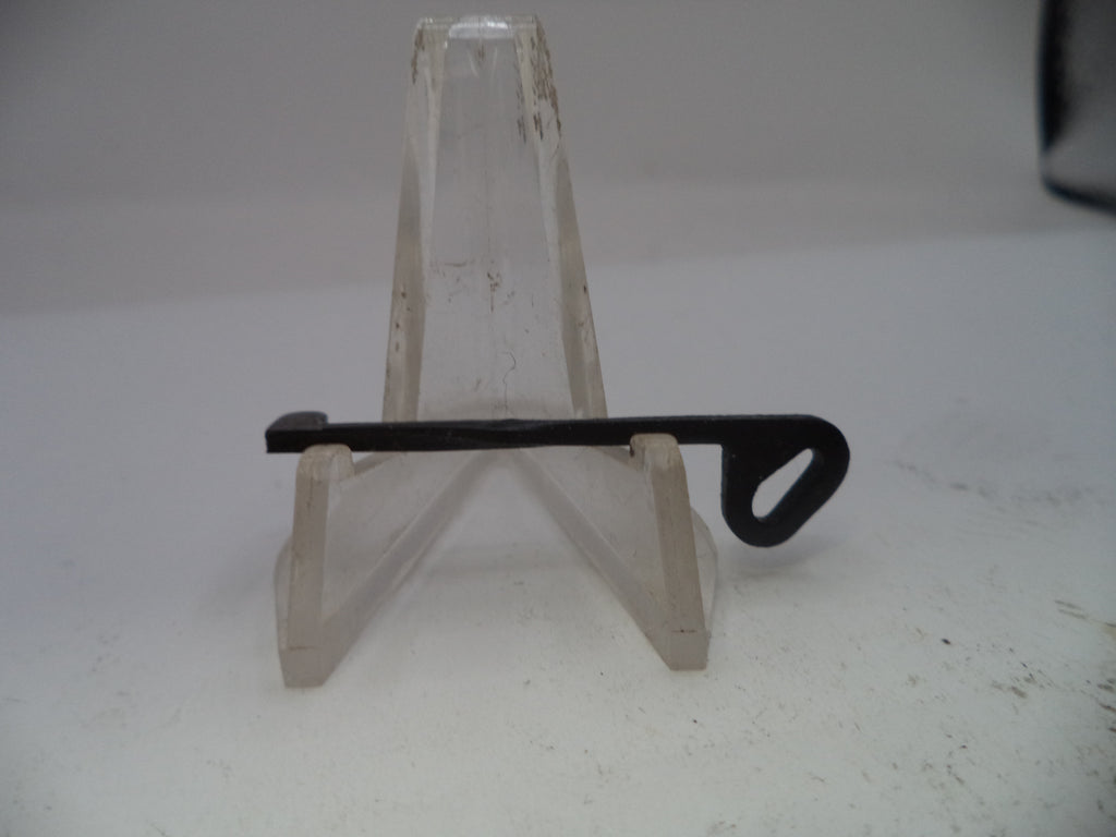 Small black metal tool on a clear acrylic stand against a white background