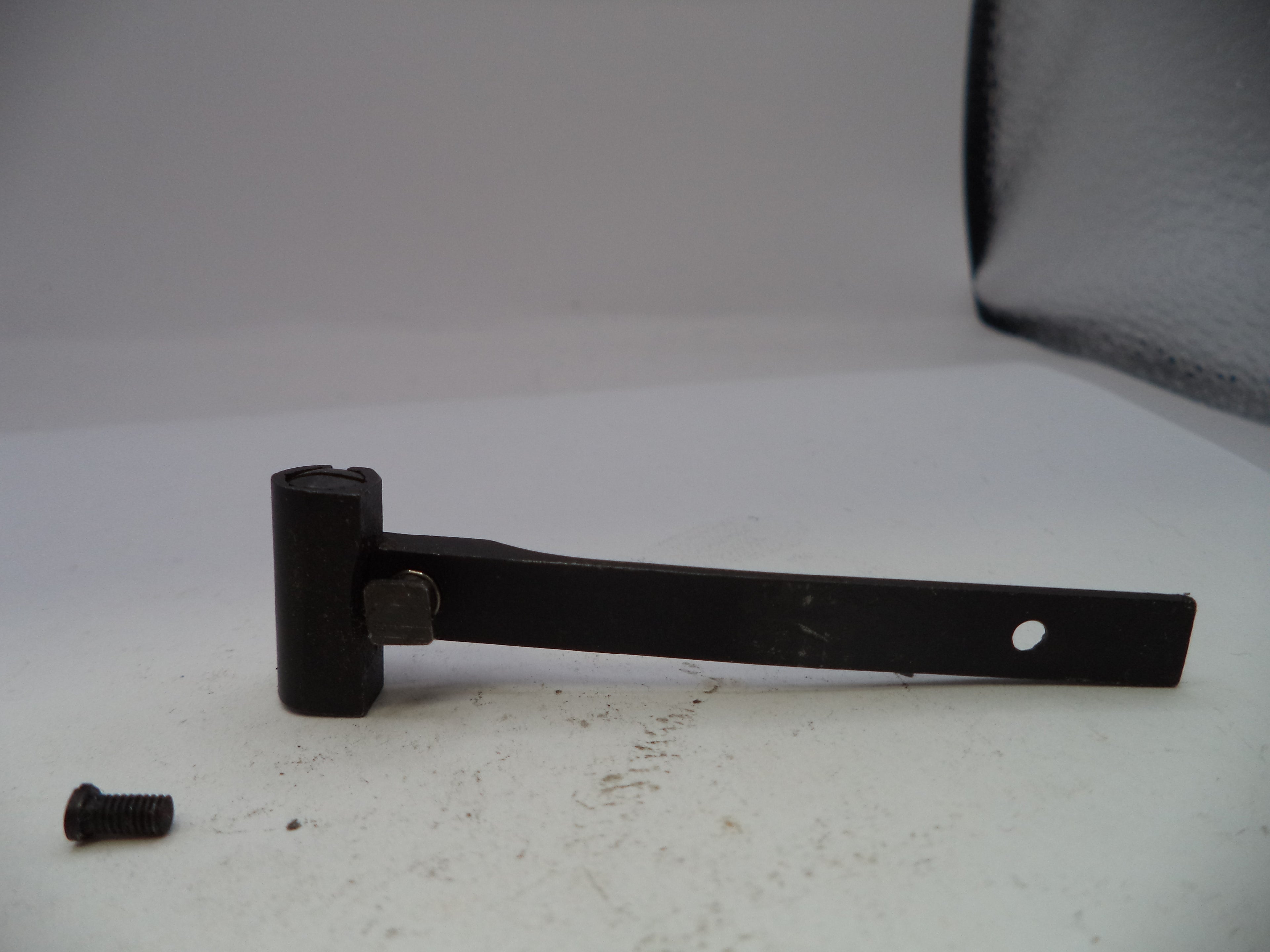 Black metal lever with a screw on a white background