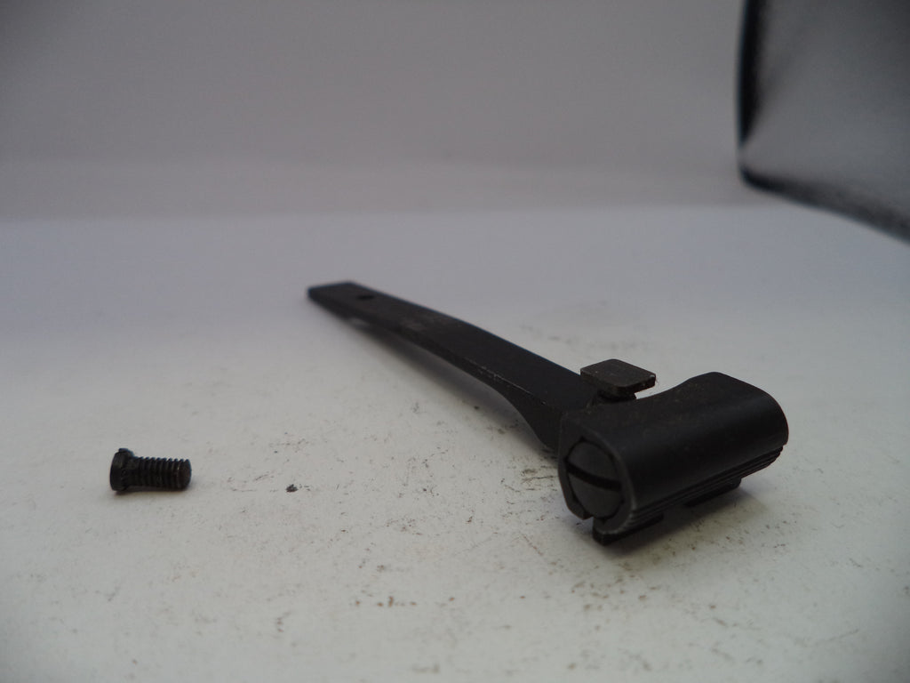 Black metal lever and screw on a white surface