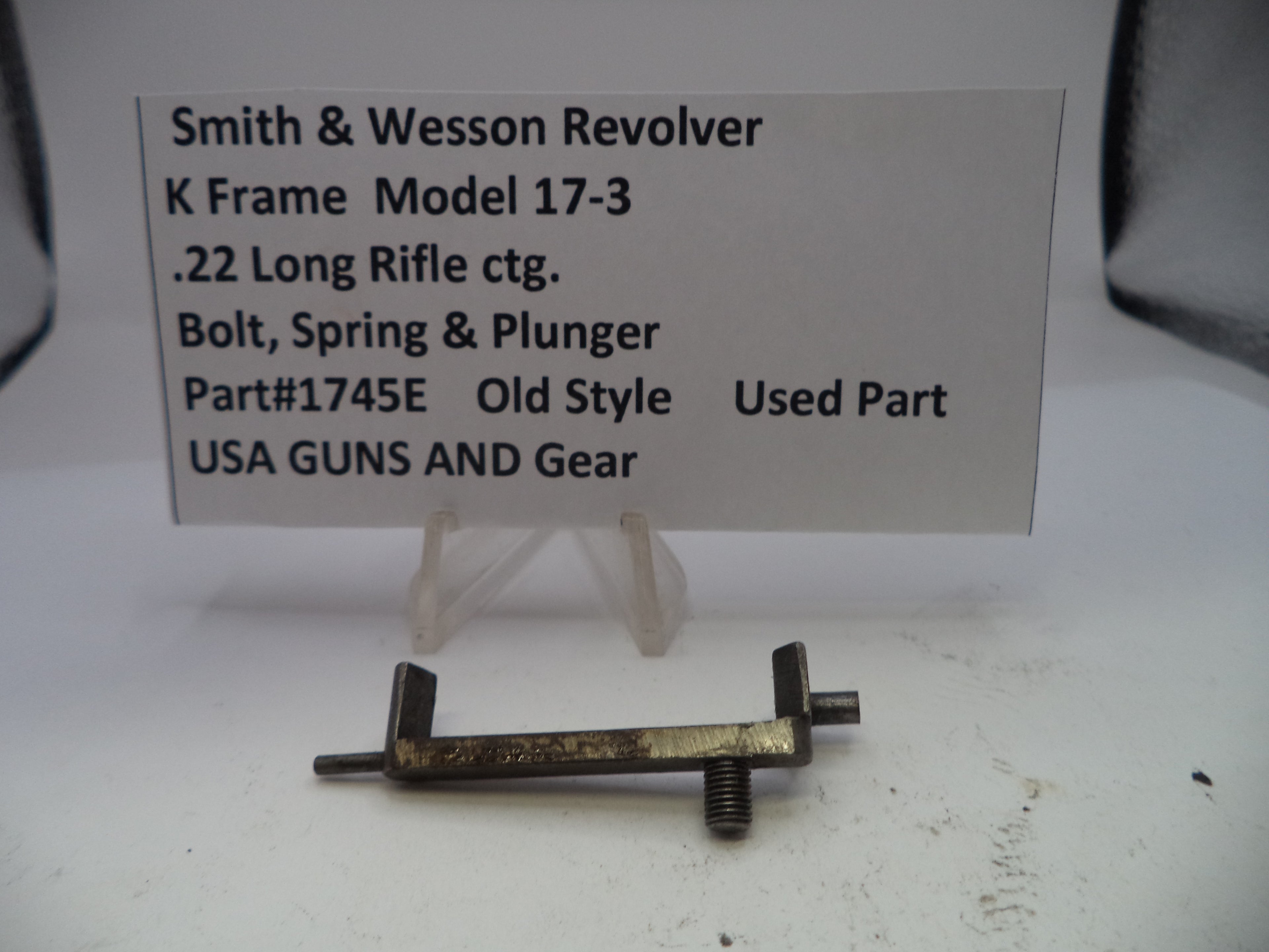 Smith & Wesson revolver part on a white background with descriptive text card.