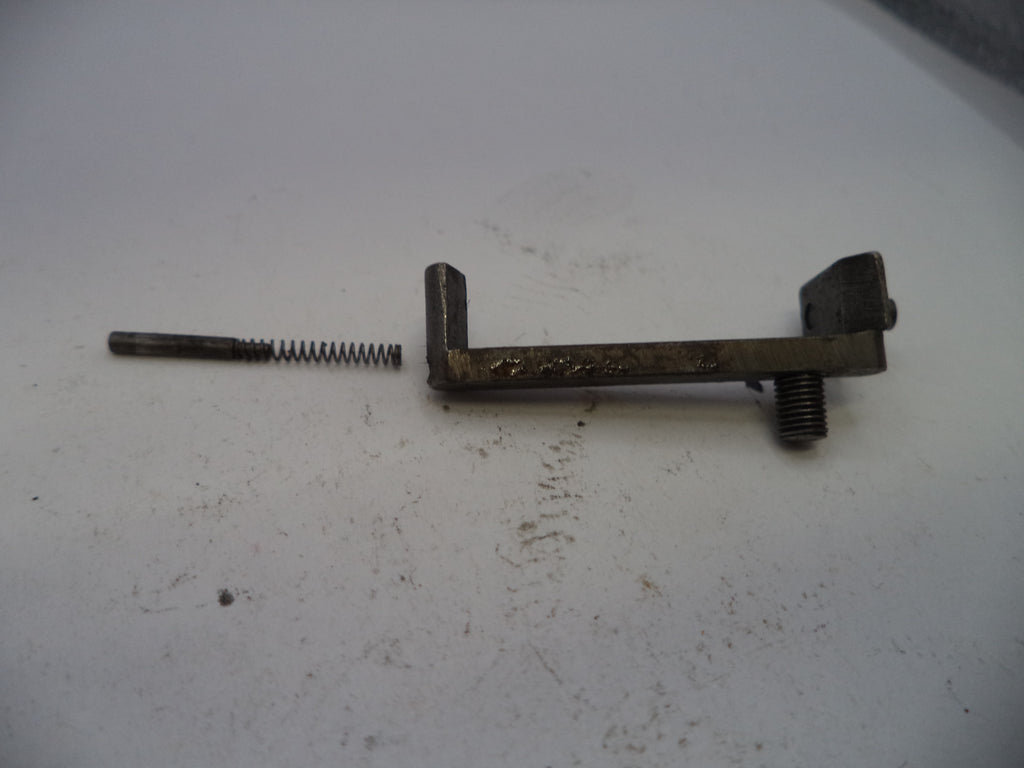 Metal lever with a spring on a white surface