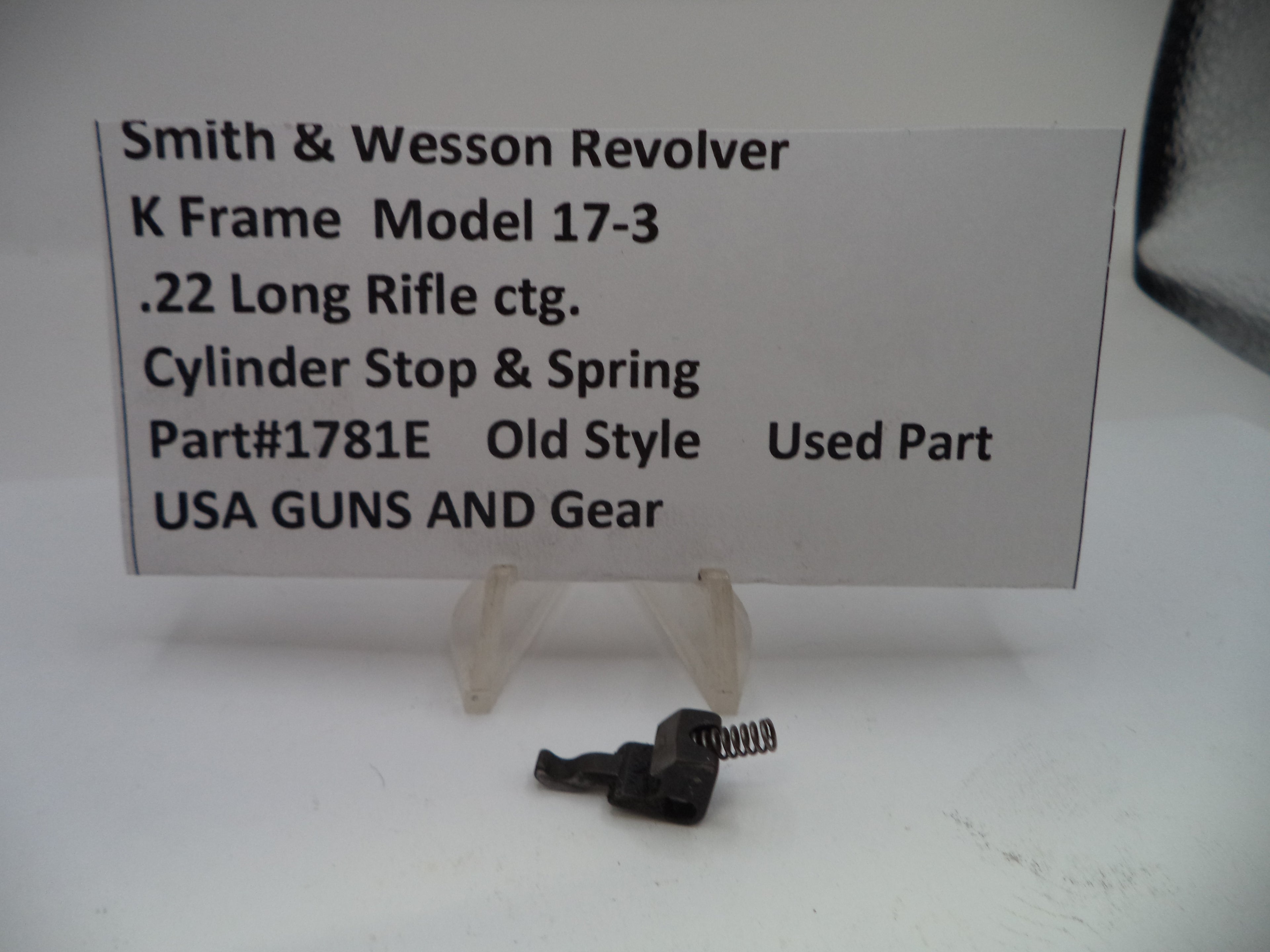 Smith & Wesson revolver part with descriptive card on a white background