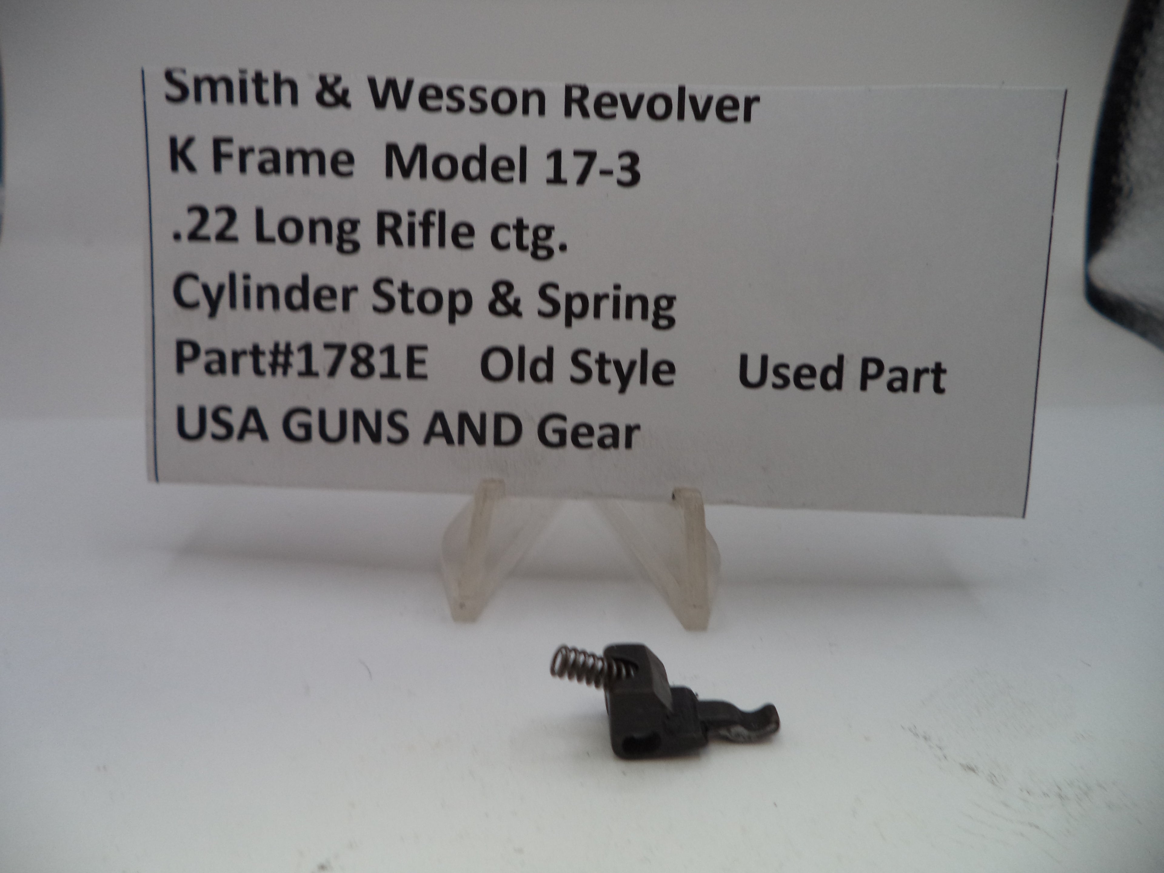 Smith & Wesson revolver part with descriptive card on a white background