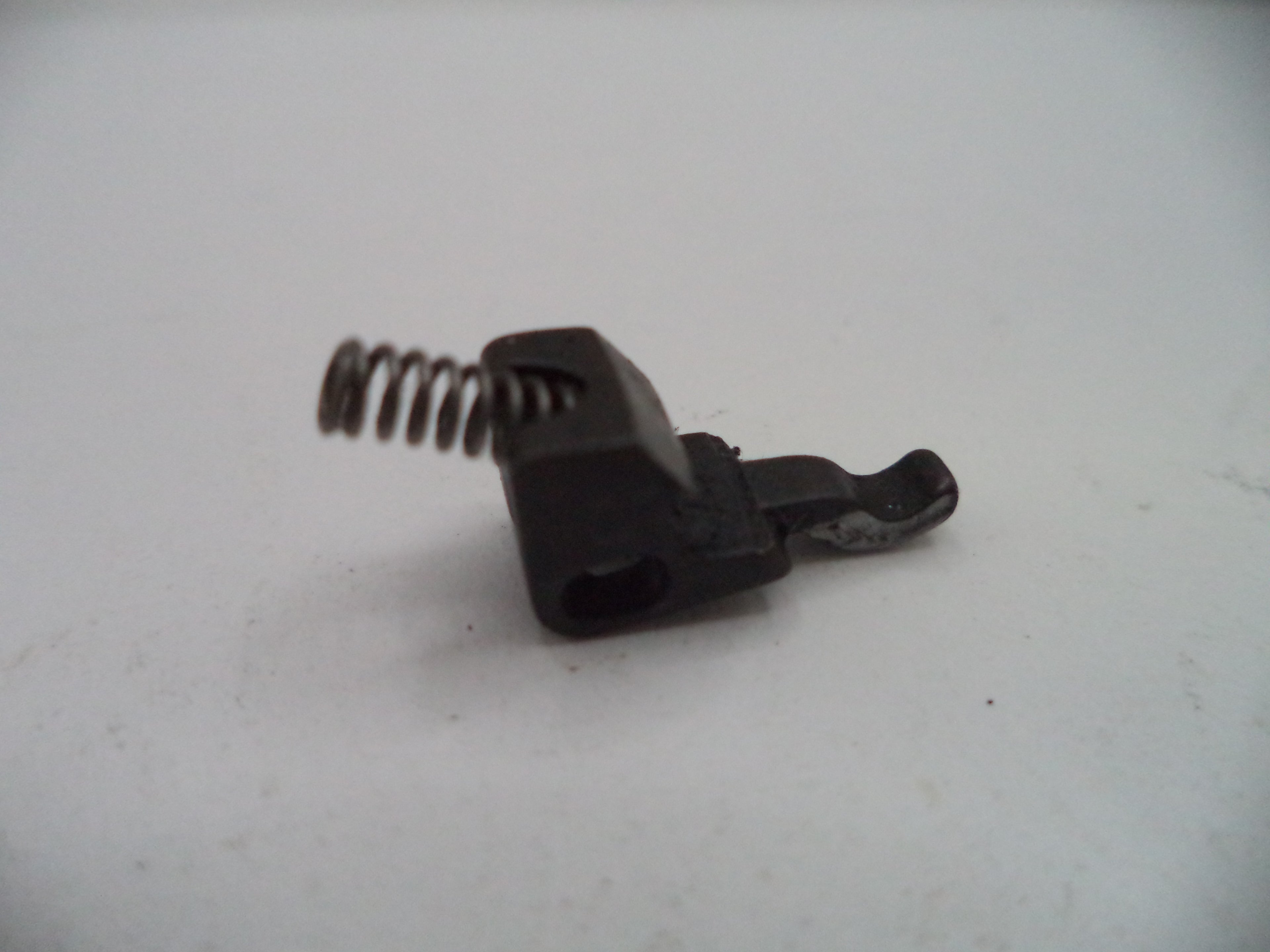Black plastic clip with a spring on a white background