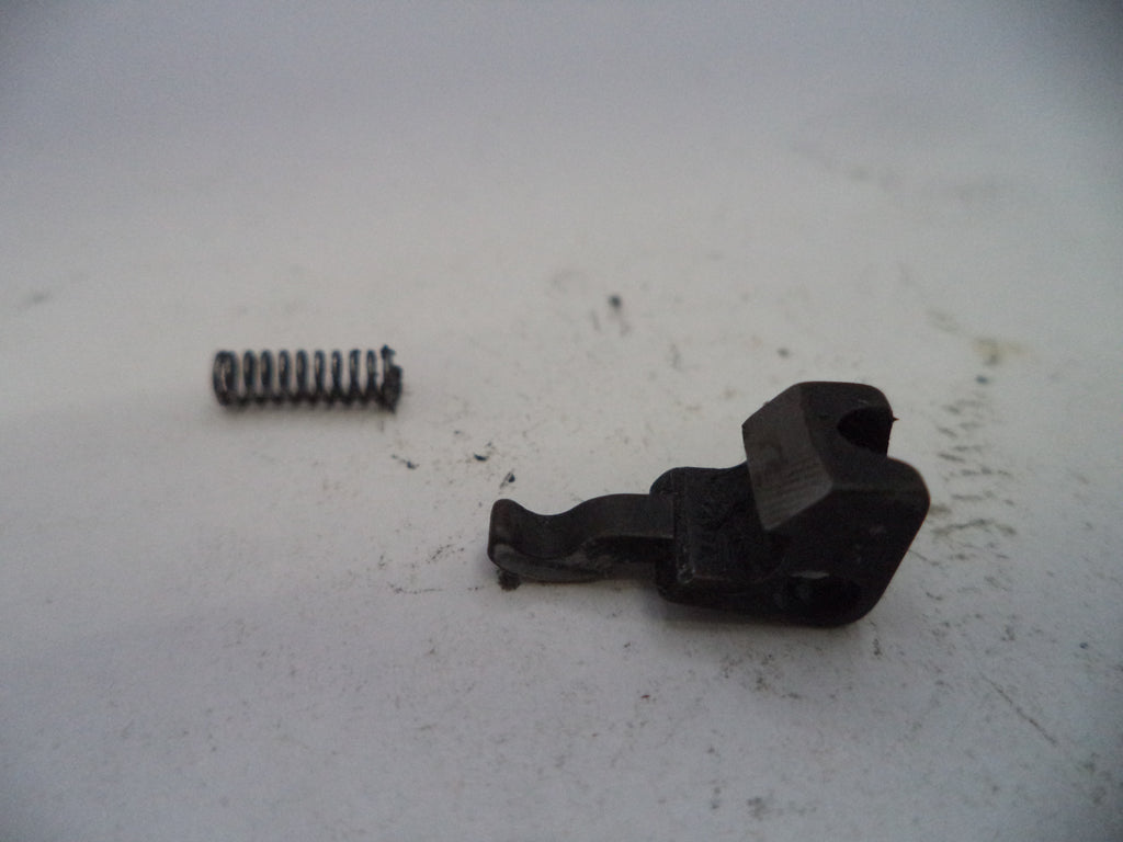 Two black metal components on a white surface