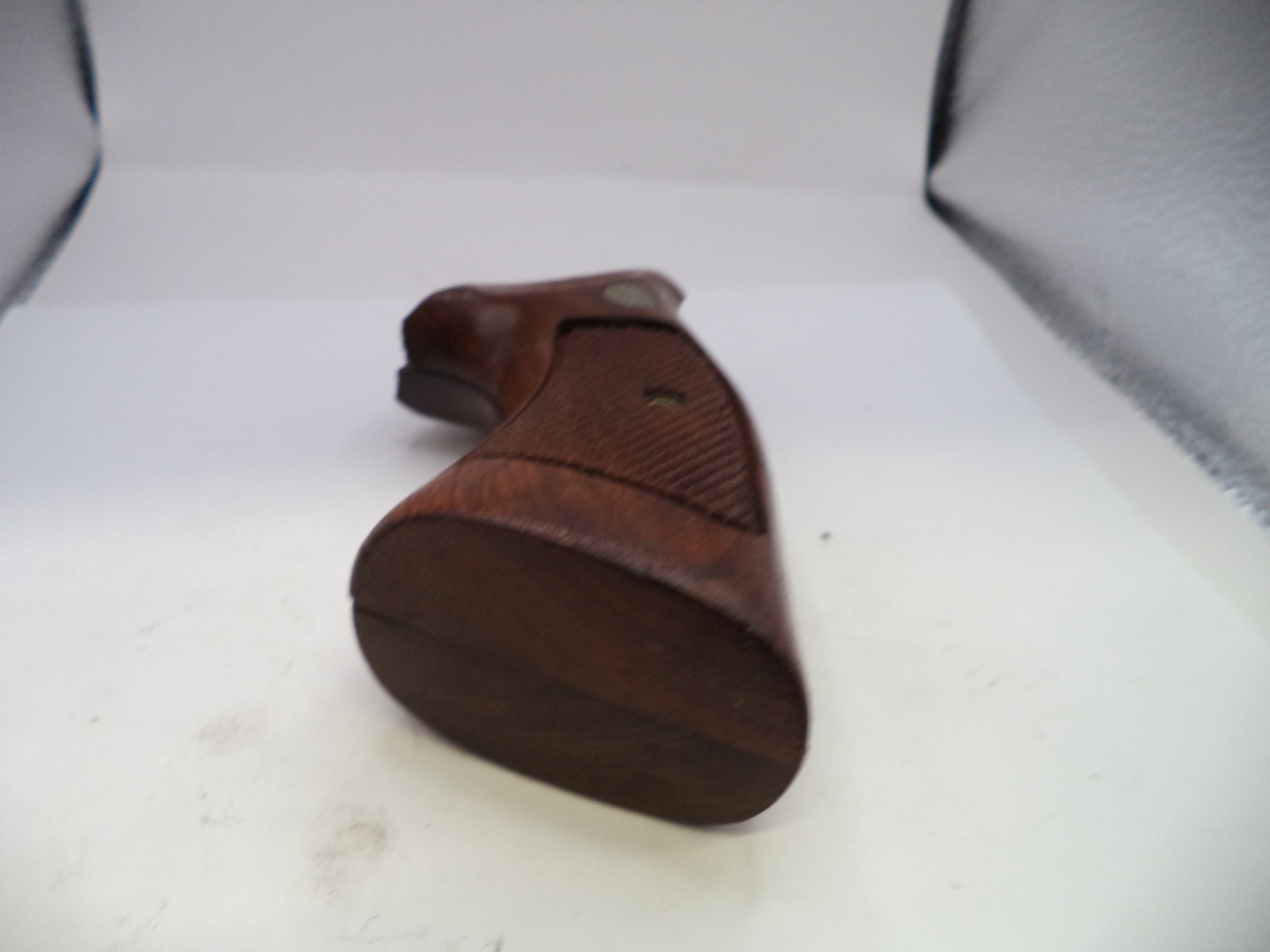 Wooden gun grip on a white background