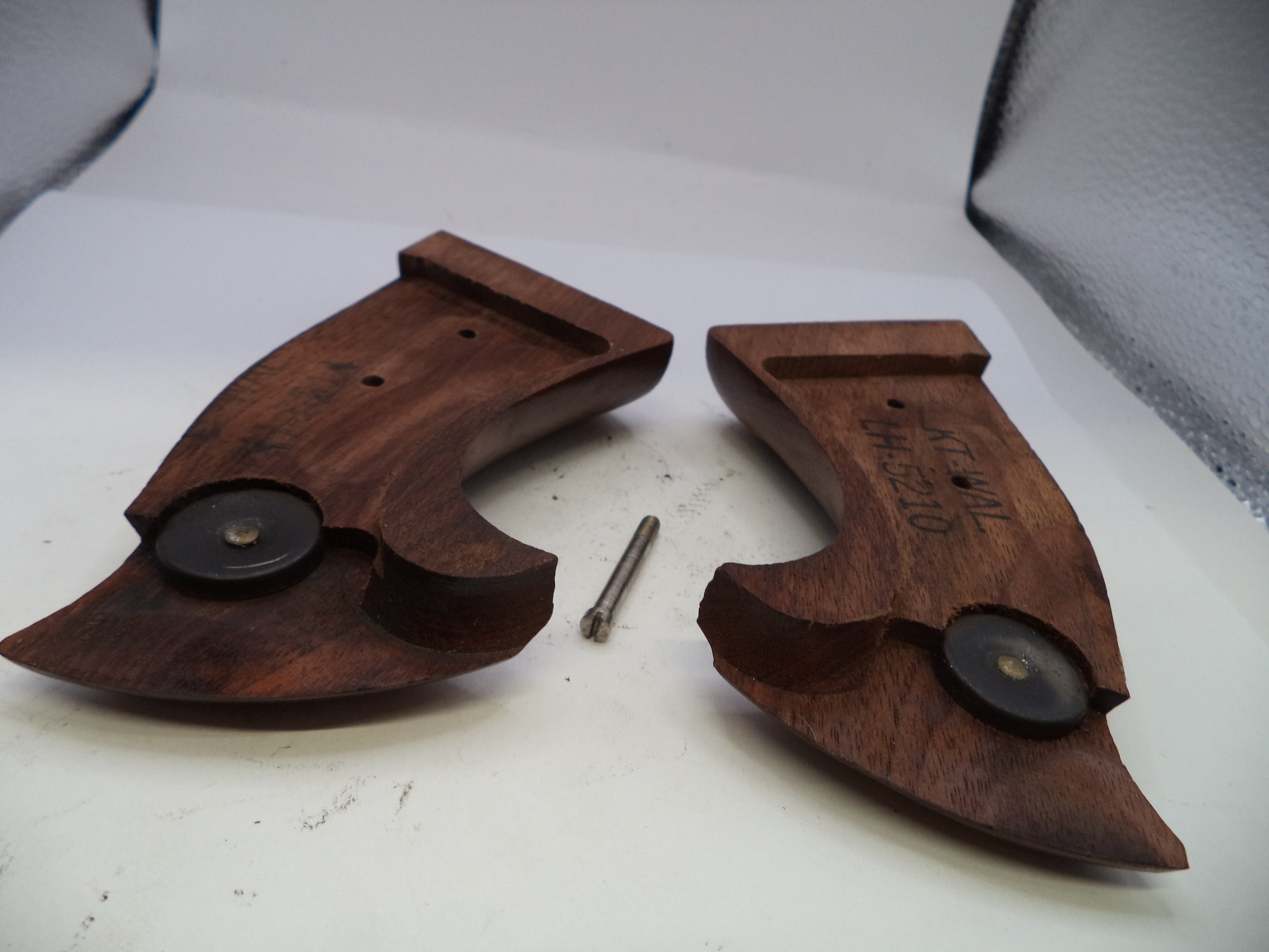 Wooden gun stocks with metal components on a white background