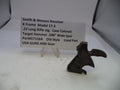 Smith & Wesson revolver part on a white surface with a label